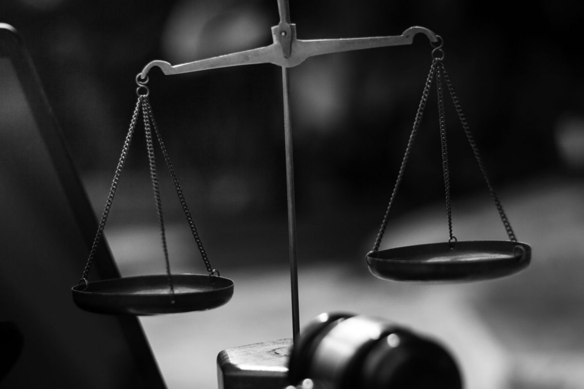 justice and law concept.Male judge in a courtroom on wooden table and Counselor or Male lawyer working in office. Legal law, advice and justice concept.